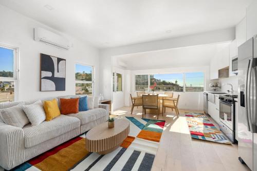 a living room with a couch and a table at Pacific Coast Suites - Oceanfront Living in Los Angeles