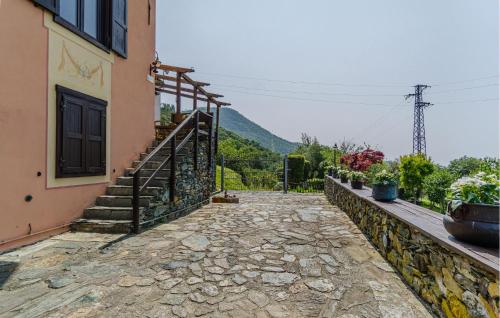 a stone walkway next to a building with a staircase at Nice Home In Fraz, Alpicella, Varaz in Il Pero
