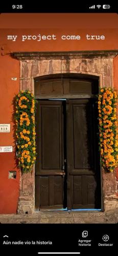a front door of a building with flowers on it at Hotel Casa Rosario in San Miguel de Allende