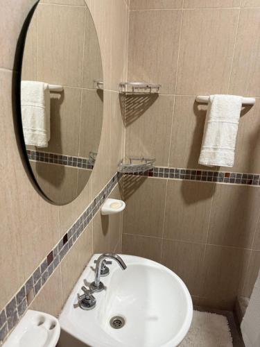 a bathroom with a sink and a mirror at Departamento en Zona Norte A ESTRENAR con hermosa vista in Salta