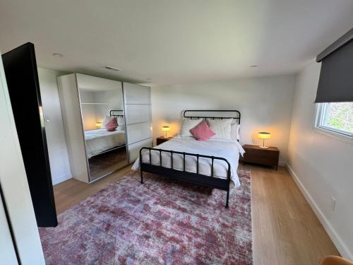 a bedroom with a bed and a large mirror at Newly Renovated house in the Best location of TriCities in Johnson City
