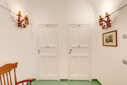 a room with two white doors on the wall at Villa Calypso in Capri