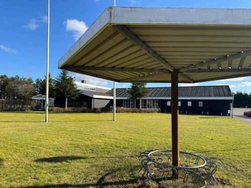 a pavilion in a field in front of a building at 4 person holiday home in Hampen in Hampen