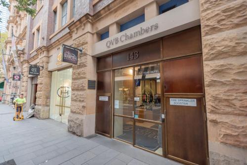 a store front of a building with a revolving door at YEHS Hotel Sydney QVB in Sydney