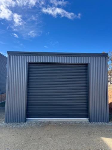 a large metal garage door on a building at Wuelf & the Fallow in Moonbah