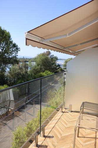 a balcony with chairs and a view of the city at Villa Osmani in Shkodër
