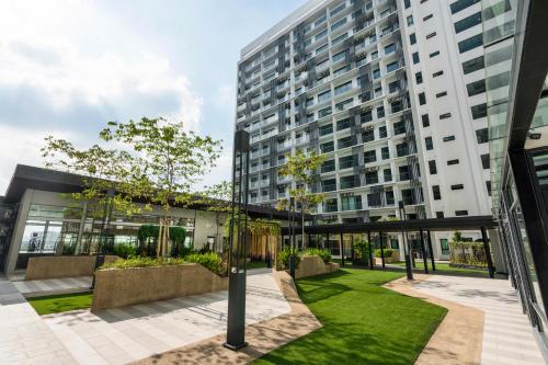 an apartment building with a garden in front of it at FOX Hotel Glenmarie Shah Alam in Shah Alam