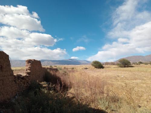 an old building in the middle of a field at Luna Calchaqui in Payogasta