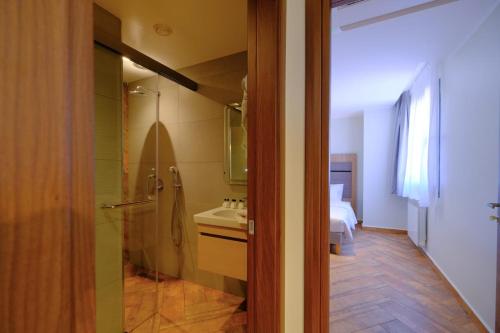 a bathroom with a sink and a toilet in a room at Hôtel Appart Boumellit Centre Ville Jijel in Jijel