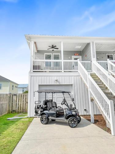 a golf cart parked in front of a house at Turtle Cove Beach Retreat GOLF CART Included in Carolina Beach