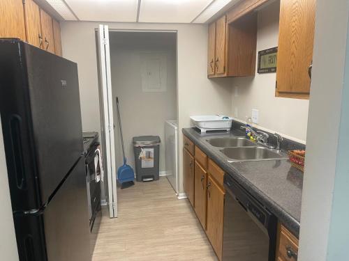 a kitchen with a refrigerator and a sink at Sweet home in Indianapolis