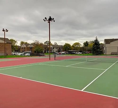 a tennis court with two tennis courts at Sweet home in Indianapolis