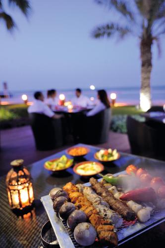 a tray of food on a table with food at Mövenpick Hotel & Resort Al Bida'a in Kuwait