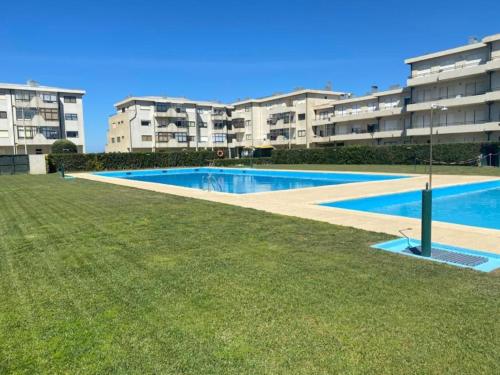 a swimming pool in front of some apartment buildings at Ti Beach House in Mindelo