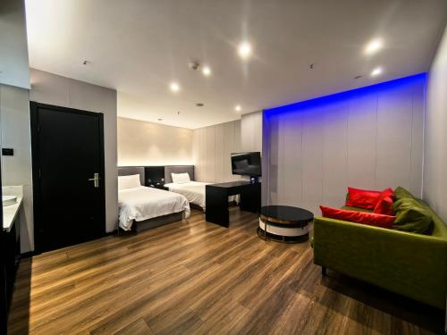 a hotel room with a bed and a couch at Ibis Beijing Shichahai Gulou Street Subway Station Hotel in Beijing