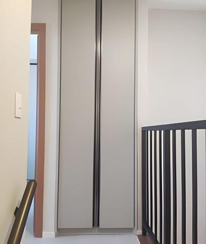 a metal elevator in a room with white walls at Apartamento Pé na Areia Cond Alphaville Guarajuba in Camaçari
