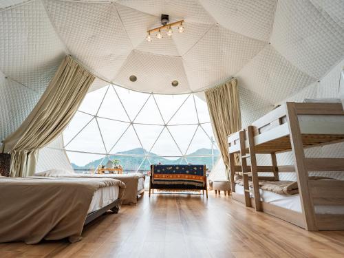 a room with two beds and a large window at Calm Lanai Harbor in Nichinan