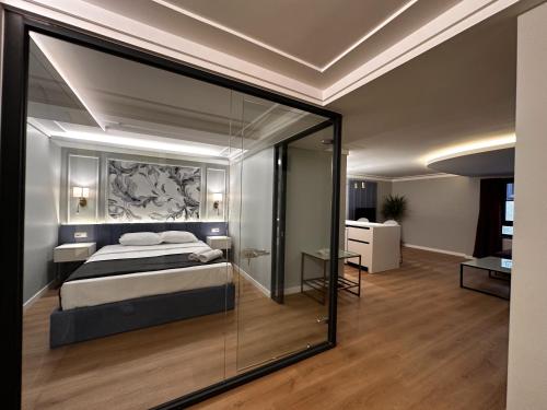 a bedroom with a bed and a glass wall at OTTO Tunalı Houses in Ankara