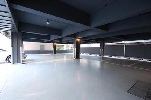 an empty parking garage with a car parked in it at Noel Business Hotel in Busan
