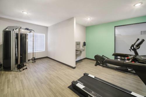 a room with a gym with a treadmill and a mirror at ECHO Suites Extended Stay by Wyndham Fort Worth Alliance in Fort Worth