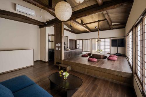 a living room with a couch and a tv at Nananohi Machiya House in Takayama