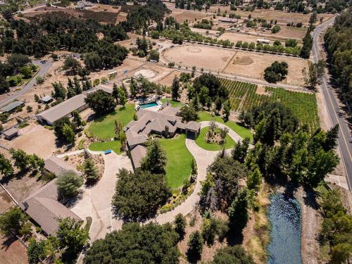 an aerial view of a house with a river at The Oaktree Estate by Fieldtrip 7 Acre Private Resort with Lake Pool Vineyard in Lake Elsinore