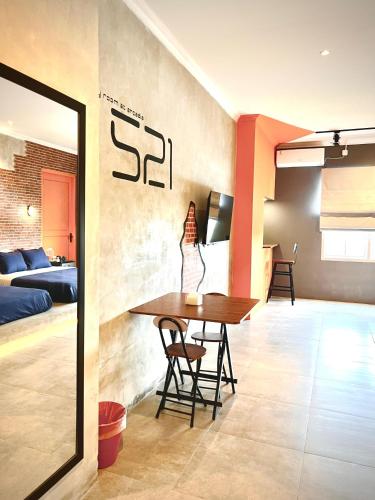 a dining room with a table and a bedroom at the AMARTYA in Yogyakarta