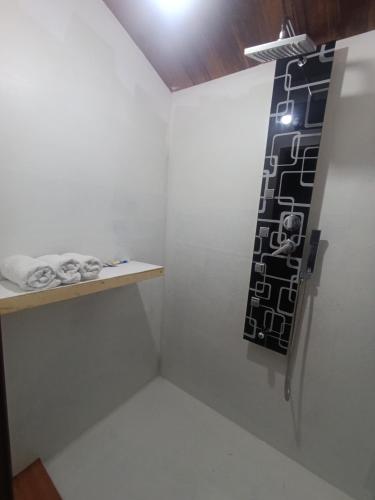 a room with a white wall with a shelf and a light at Luna Titicaca Grebe in Puno
