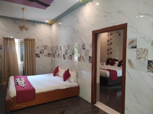 a bedroom with two beds and a mirror at Sharma Jee Farm House Yercaud in Yercaud