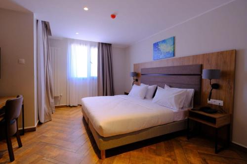 a bedroom with a large bed in a hotel room at Hôtel Appart Boumellit Centre Ville Jijel in Jijel