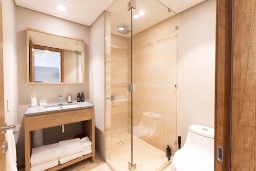 a bathroom with a shower and a sink at Punto Nima, Spectacular Pool with Ocean View in San José del Cabo