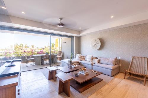 a living room with a couch and a table at Punto Nima, Spectacular Pool with Ocean View in San José del Cabo