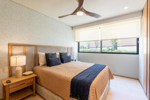 a bedroom with a bed and a window at Punto Nima, Spectacular Pool with Ocean View in San José del Cabo