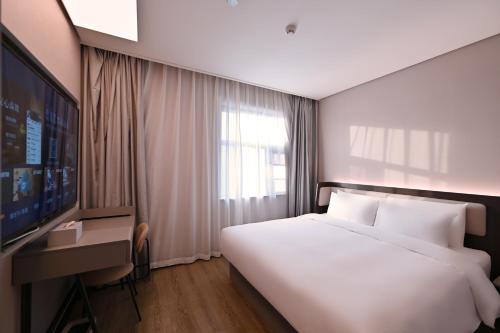 Postel nebo postele na pokoji v ubytování Hanting Hotel Beijing Garden Expo Park Dujiakan
