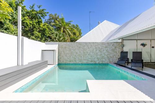a swimming pool in the backyard of a house at Serenity Villa with heated POOL & Beach access in Port Douglas
