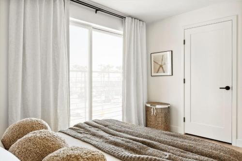 a bedroom with a bed with a large window at Tide House - Unit C - Modern Seaside 1BD w Parking in El Segundo