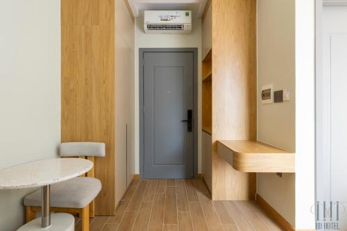 a hallway with a door and a table and chairs at HD Hotel Sunset Town in Phu Quoc