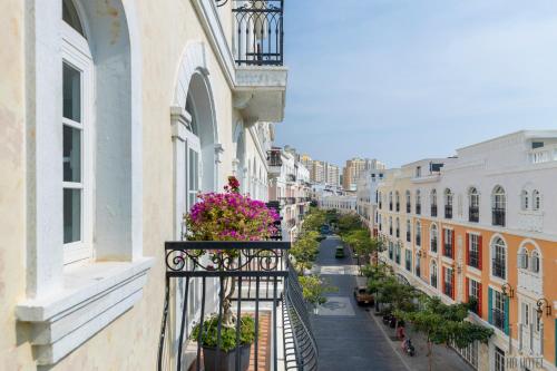 a city street with buildings and flowers on a balcony at HD Hotel Sunset Town in Phu Quoc