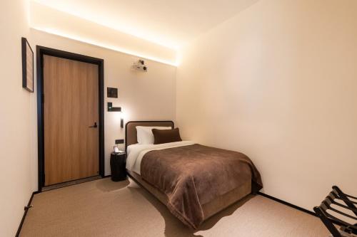 Ένα ή περισσότερα κρεβάτια σε δωμάτιο στο The Moment Hotel