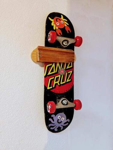 a skateboard hanging on a wall at Don Jiménez Guesthouse in Puerto Jiménez