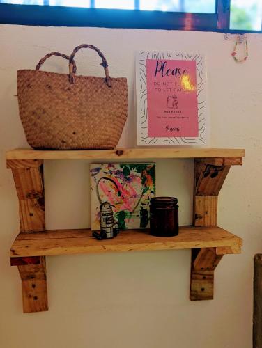a shelf with two bags and a basket on it at Don Jiménez Guesthouse in Puerto Jiménez
