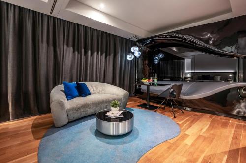 a living room with a couch and a table at Dorsett Changi City Singapore in Singapore
