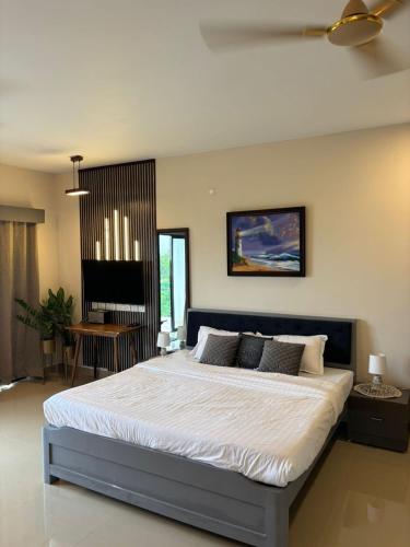 a bedroom with a large bed in a room at Forest Frame - Kudrat Nilaya Valley View with pool in Canacona
