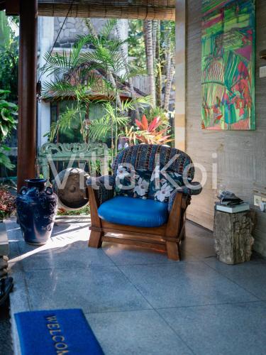 a chair sitting on the porch of a house at Villa Koi in Keramas