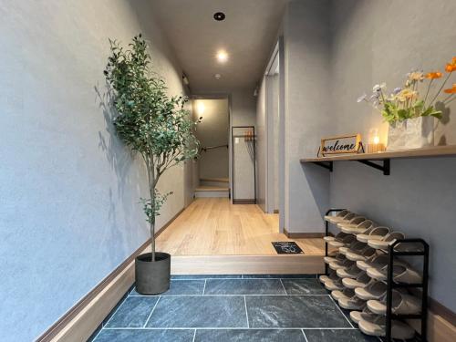a hallway with a staircase with a potted plant at nestay villa tokyo nippori in Tokyo