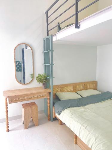 a bedroom with a bunk bed and a mirror at LENA Home in Da Lat