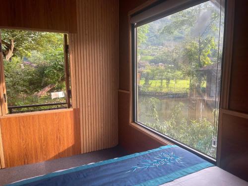 a bedroom with a window and a bed with a view at Sapa Bamboo Eco in Sa Pa