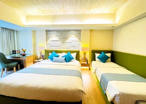 a hotel room with two beds and a desk at Cyberview Resort & Spa in Cyberjaya