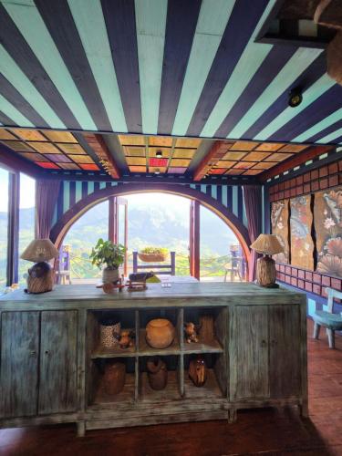 a large wooden counter in a room with a large window at Sapa Clay House - Mountain Retreat in Sa Pa