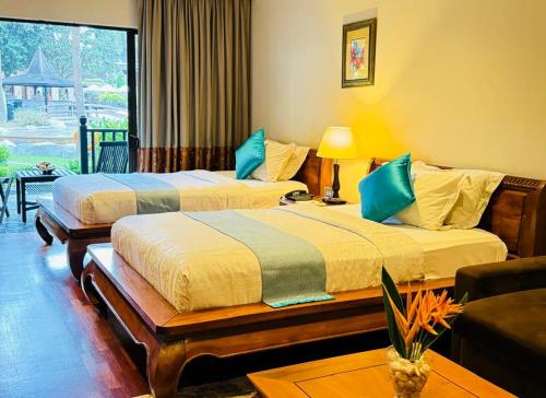 a hotel room with two beds and a couch at Cyberview Resort & Spa in Cyberjaya